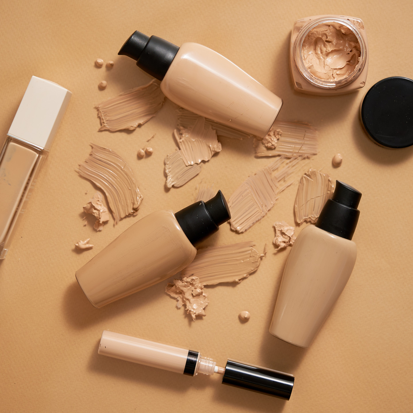 bottles of makeup foundation and samples on beige 2022 09 07 16 25 36 utc